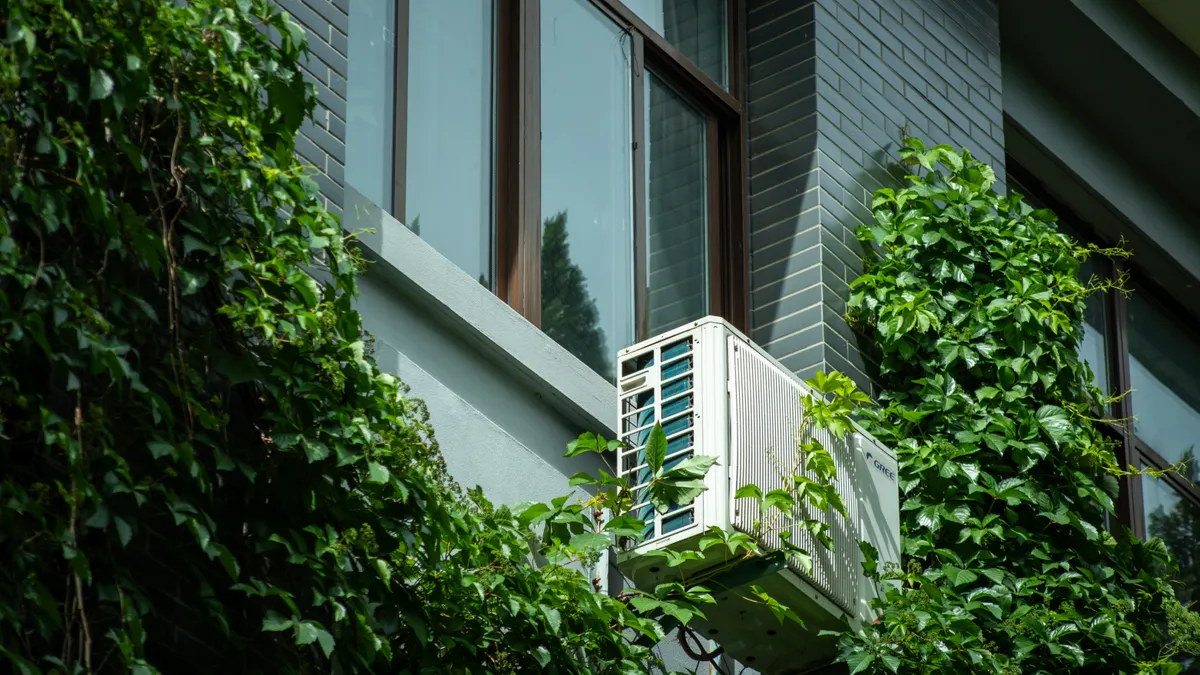 Home Energy Audits and Whole-Home Energy Savings — The Complete Guide Exterior air conditioner unit on a house wall